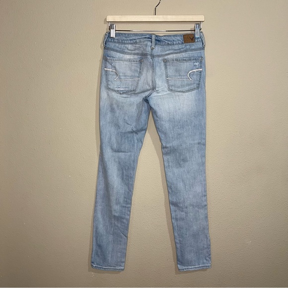 American Eagle size 4 skinny stretch light wash jeans w/ holes on the front - Picture 2 of 7